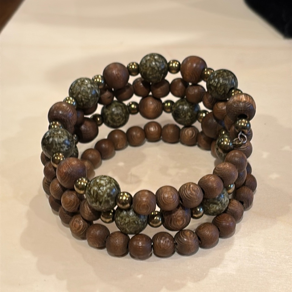 Bracelet made from memory with has wood and green beads. One size fits all.